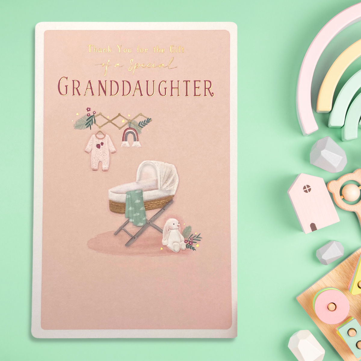 Front image with pink design, pram and baby gifts