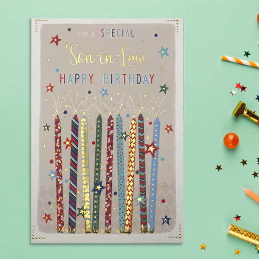 Red, blue and gold candles with stars and coloured text