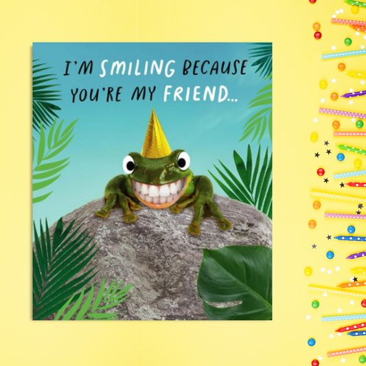 Frog in party hat with palms on rock smiling