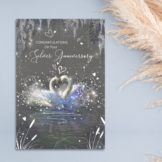 Grey card with two swans embrace surrounded with hearts
