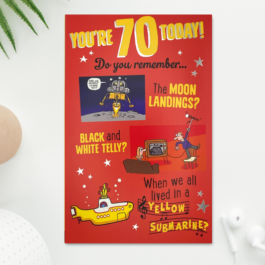 Front image of bright red card with colourful graphics from moon landing, tv and yellow submarine