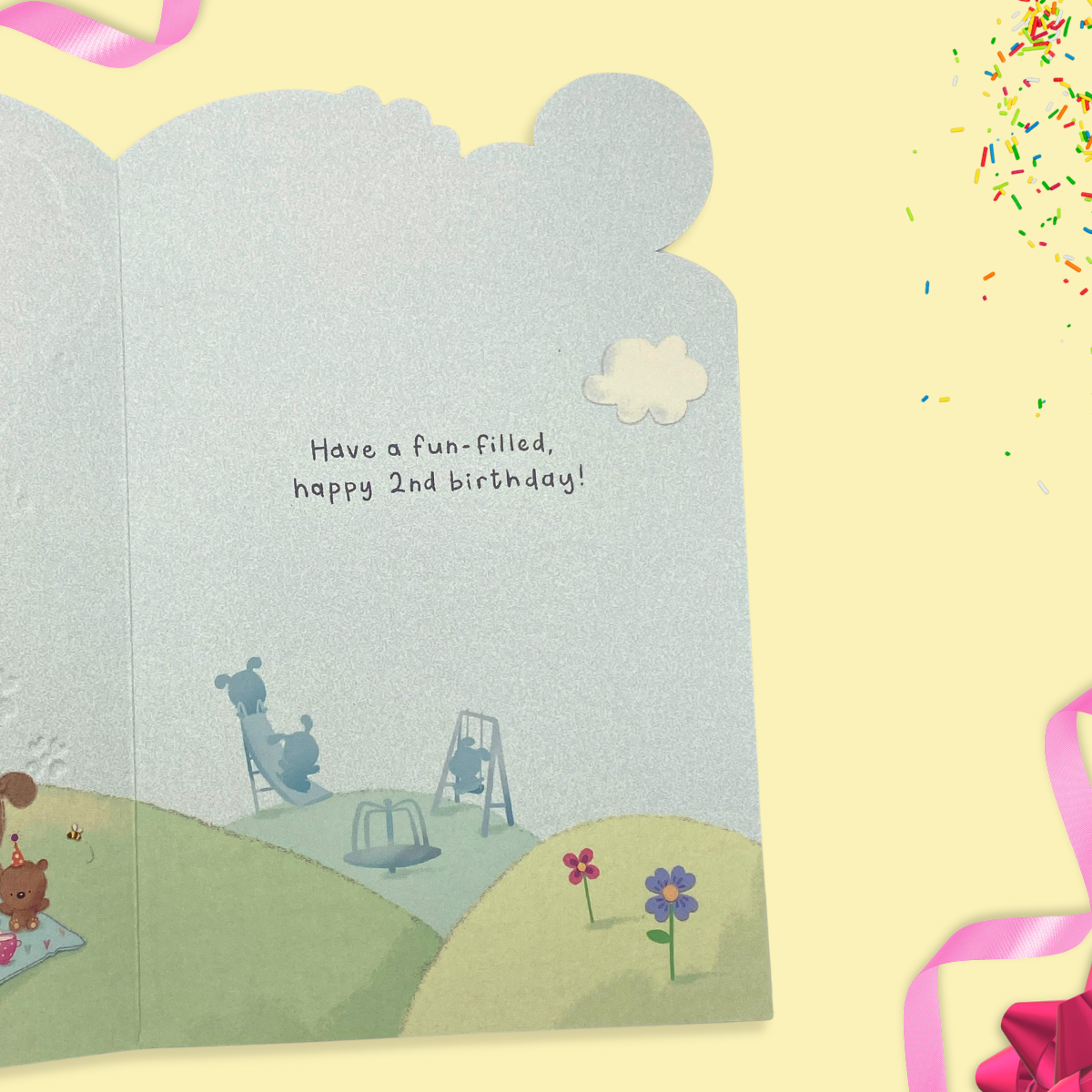 Inside image with colour print on two pages with dog having a picnic.