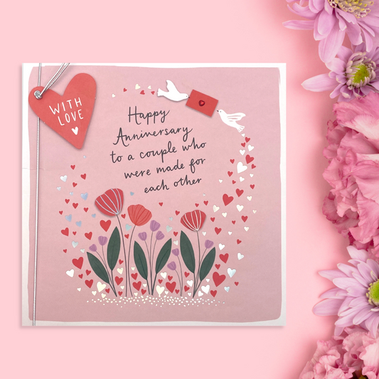 Front image showing large square anniversary card, pink design with white flowers and hearts with heart scattered