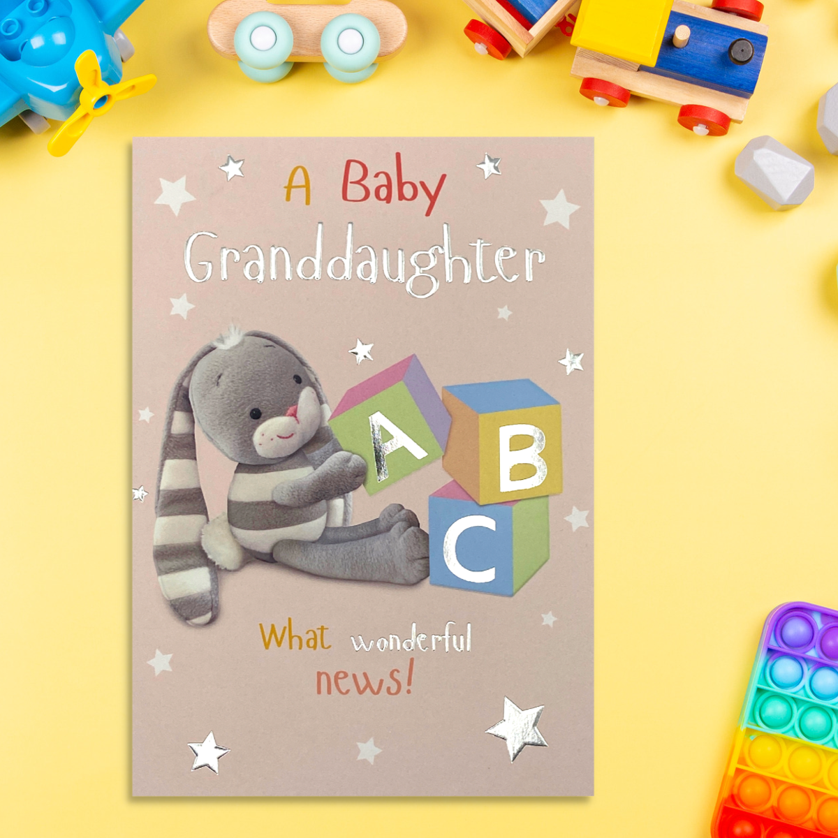 Front image with pink card, grey bunny and baby blocks