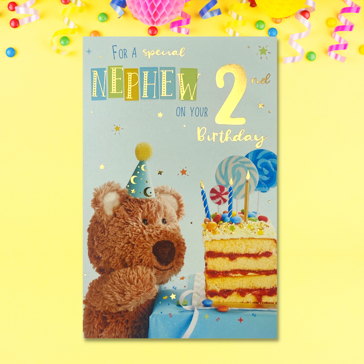 Front image with Barley Bear looking at Birthday cake and candles in party hat