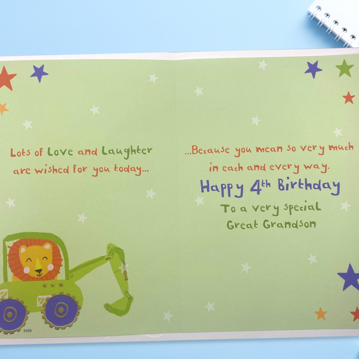 Inside image showing two coloured pages with green with multi colour text and lion in digger
