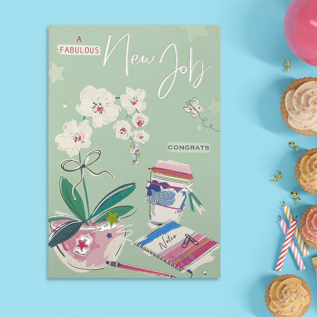 Mint green card with orchid, coffe cup and desk items