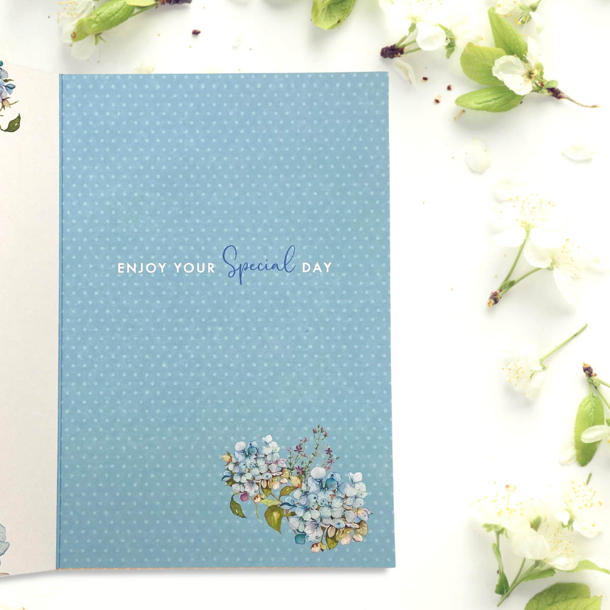 Inside image with blue background with floral details and verse