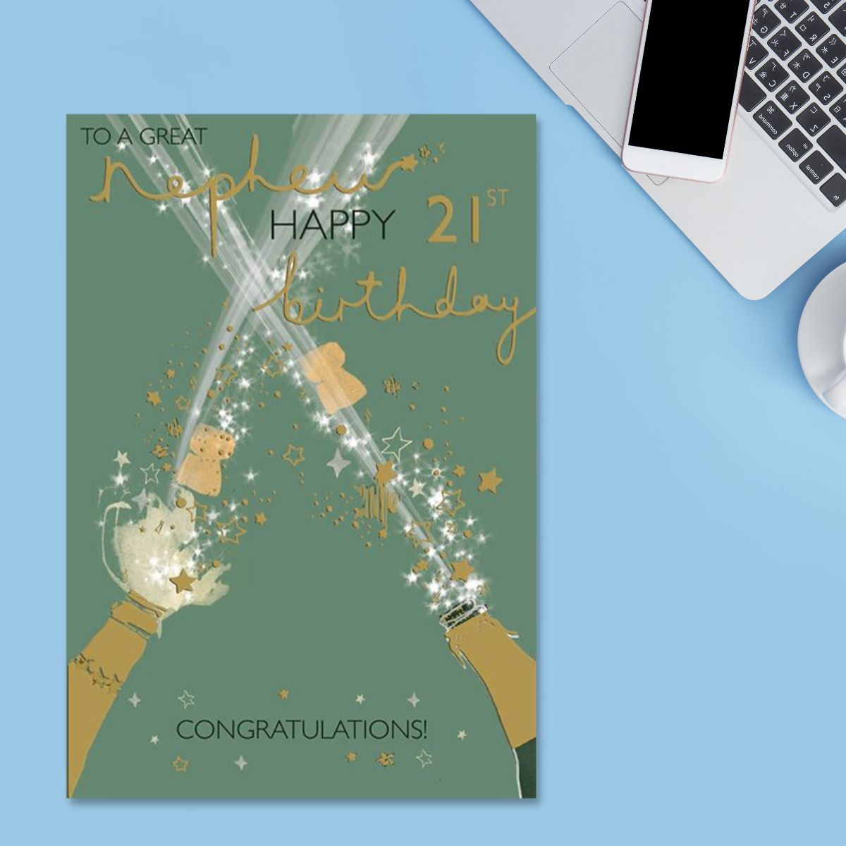 Green card with gold foil champagne bottles, stars and text