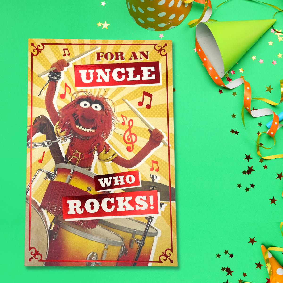 Bright yellow and red card with Muppet playing the drums