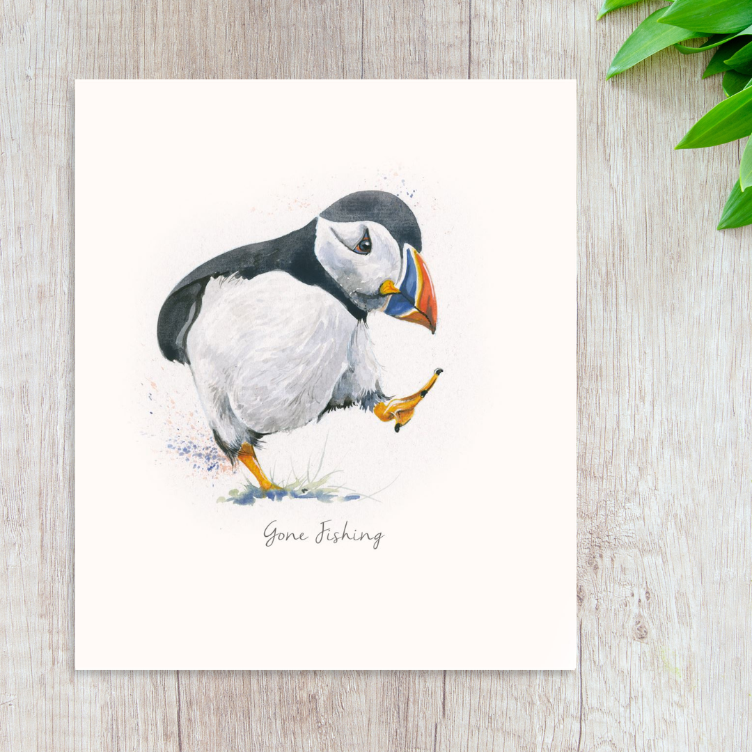 Illustrated puffin image on square card titled 'Gone Fishing'