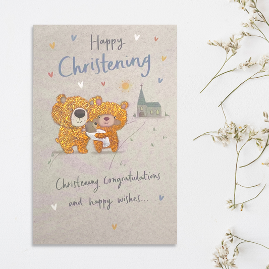 Two teddies carrying baby outside church with copper foil details