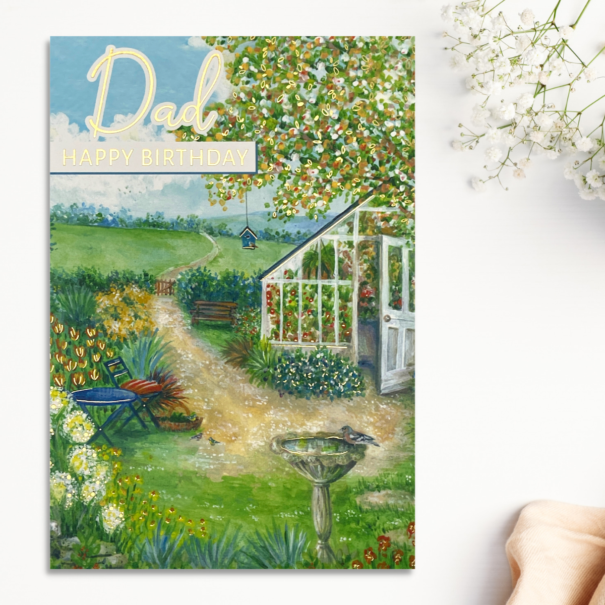 Colourful Greenhouse and bird table scene