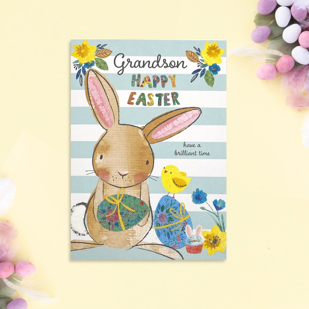 Blue and white striped background with bunny, chick and easter eggs