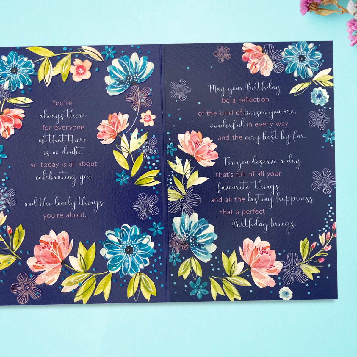 Inside image showing two pages with further verse and floral borders