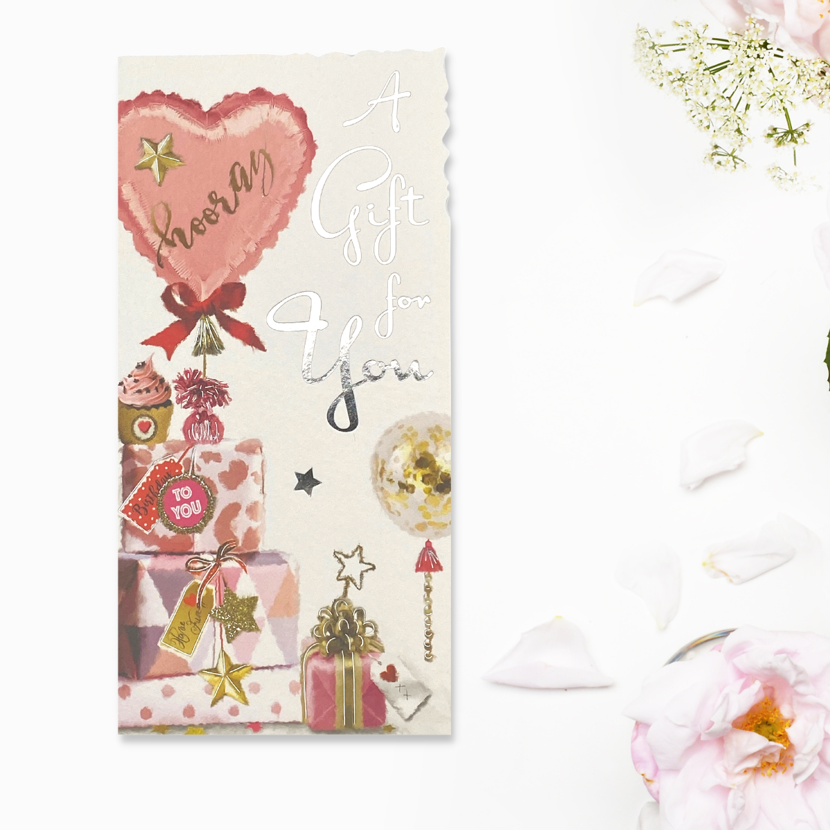 White card with pink balloon and gifts, with silver foil text
