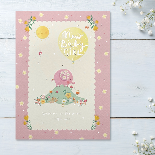 Front image with pink elephant on mound with flowers and balloon