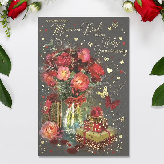 Grey card with red flowers in vase, with wrapped gifts in gold and red and hearts