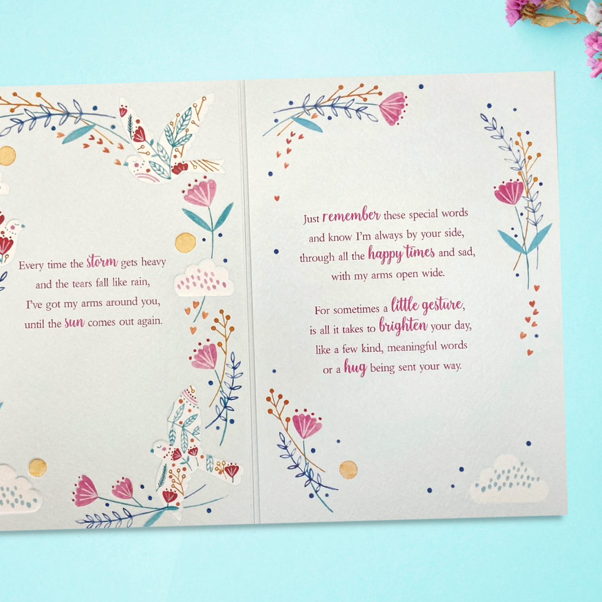 Inside image showing two pages with floral decoration and verse