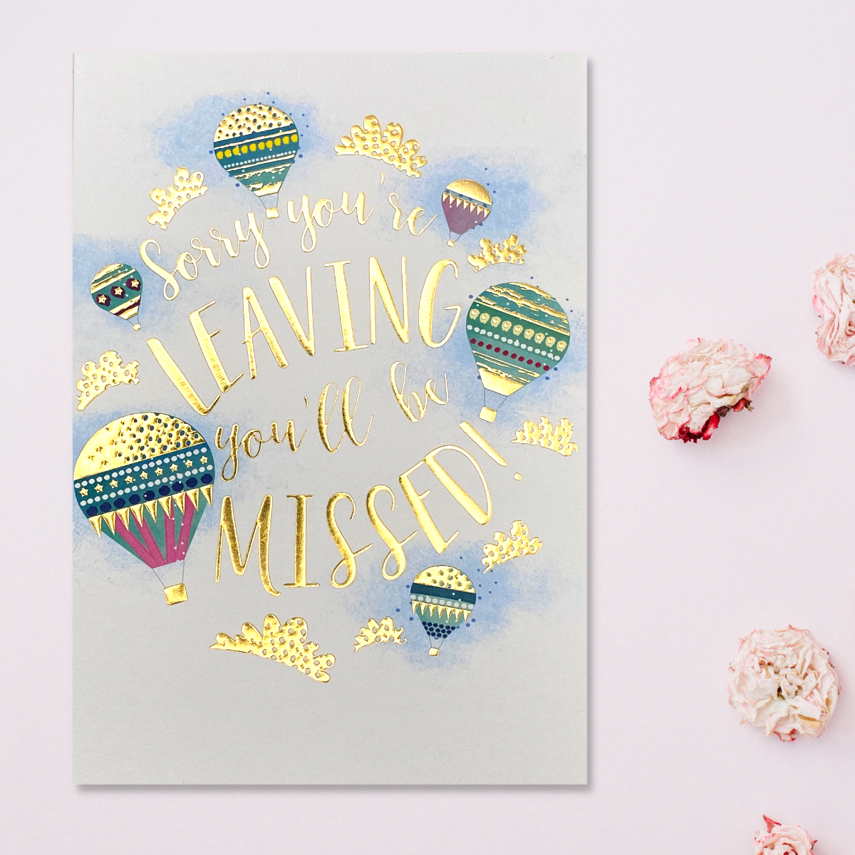 Hot air balloons surround gold foil text
