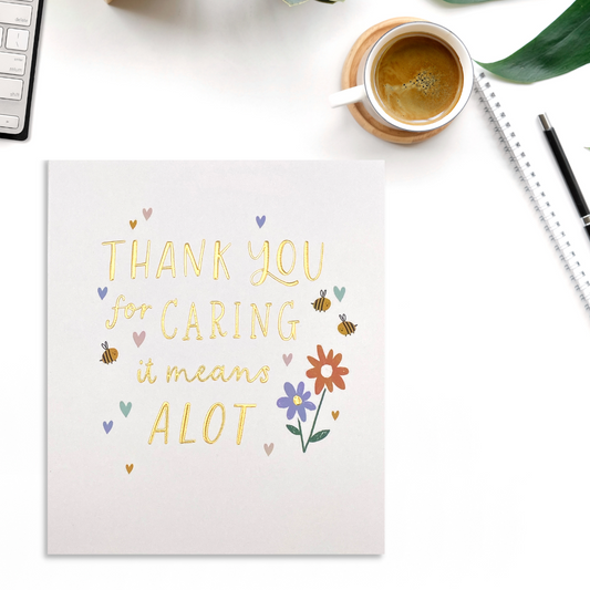 White square card with gold foil text and flowers