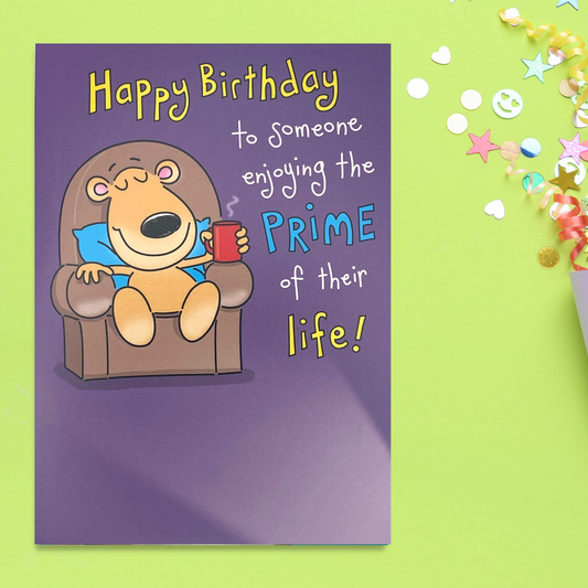 A cartoon bear in chair with cuppa relaxing