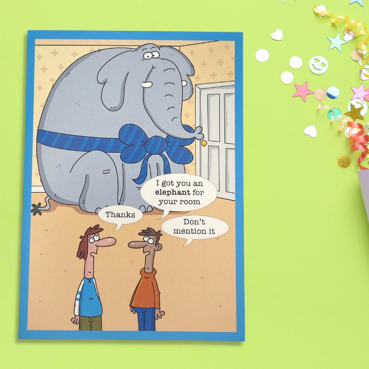 Elephant in a blue bow in corner of the room