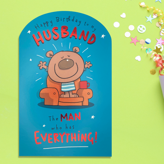 Teal die cut card with cartoon character and red foil text
