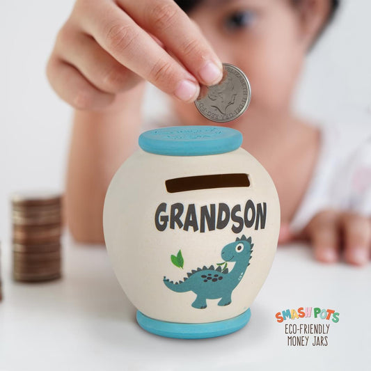 Grandson single use Smash pot money box with colourful dinosaur image. In ivory with blue top and base. Once full, smash, empty and bury the pieces in the compost heap!