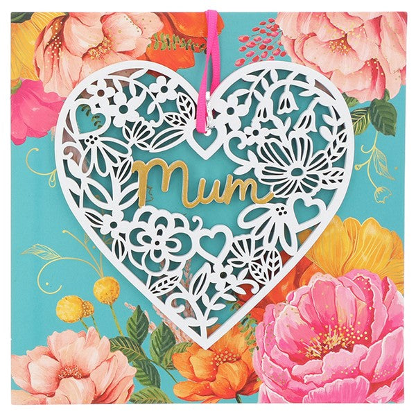 Heart shaped white wooden lace plaque with pink ribbon on colourful floral card.