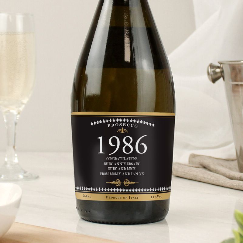 Bottle of Prosecco with a '1986' label on a white surface