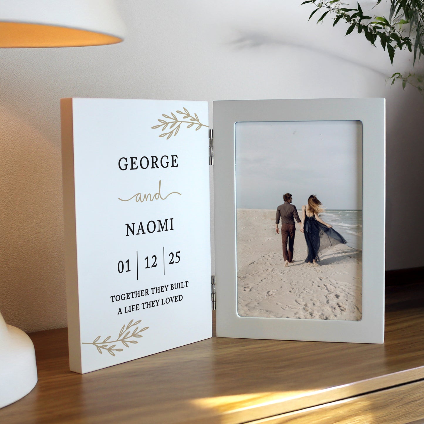 Personalised photo frame with a couple on a beach and engraved text.