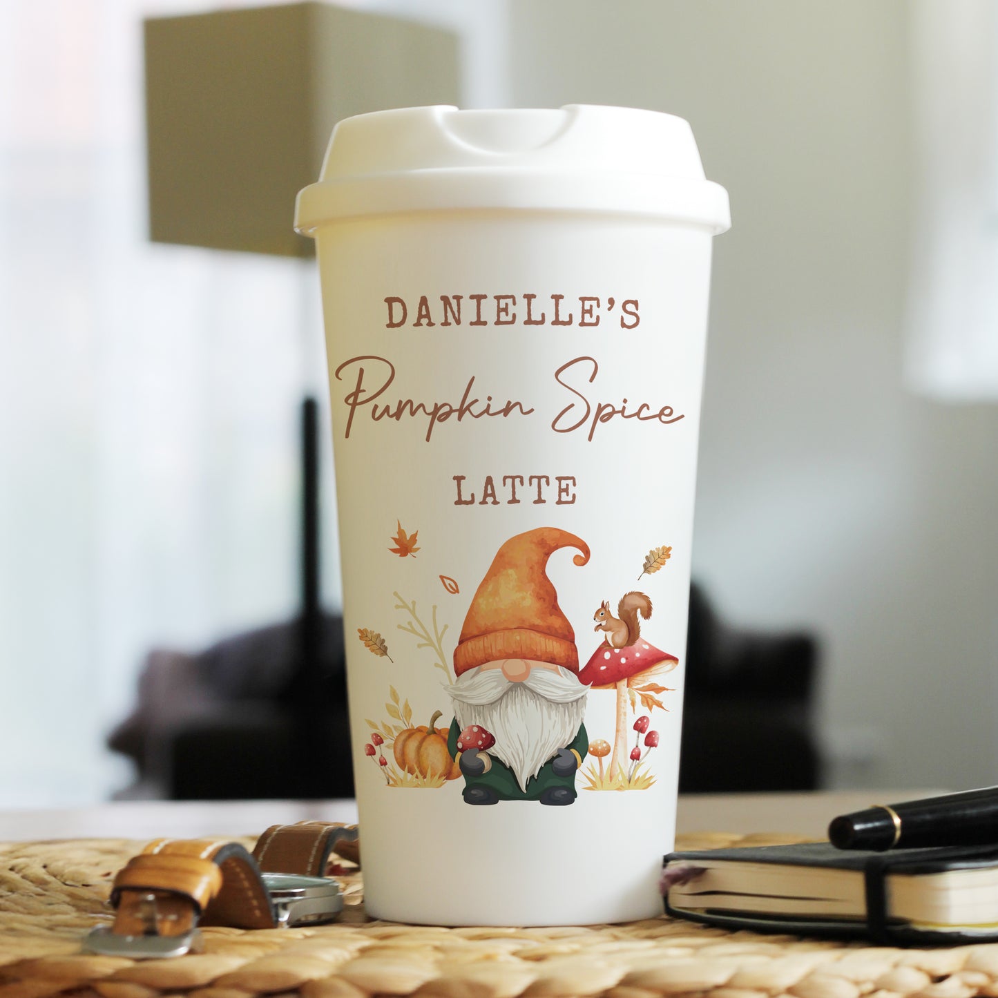 Personalised autumn themed pumpkin spice latte mug with gnome design on a blurred background