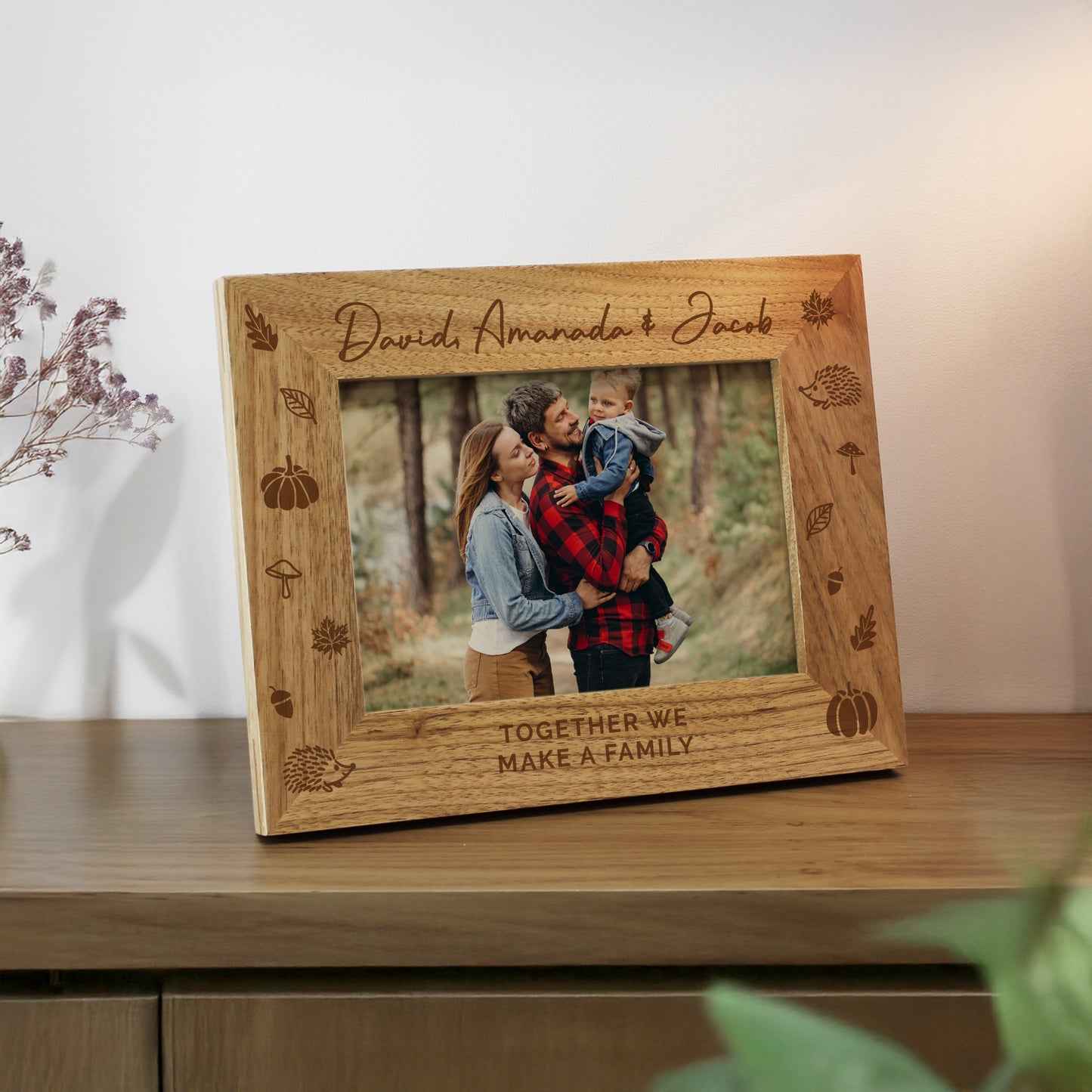 Personalised Autumn themed wooden photo frame with engraved text and family photo on a wooden surface.