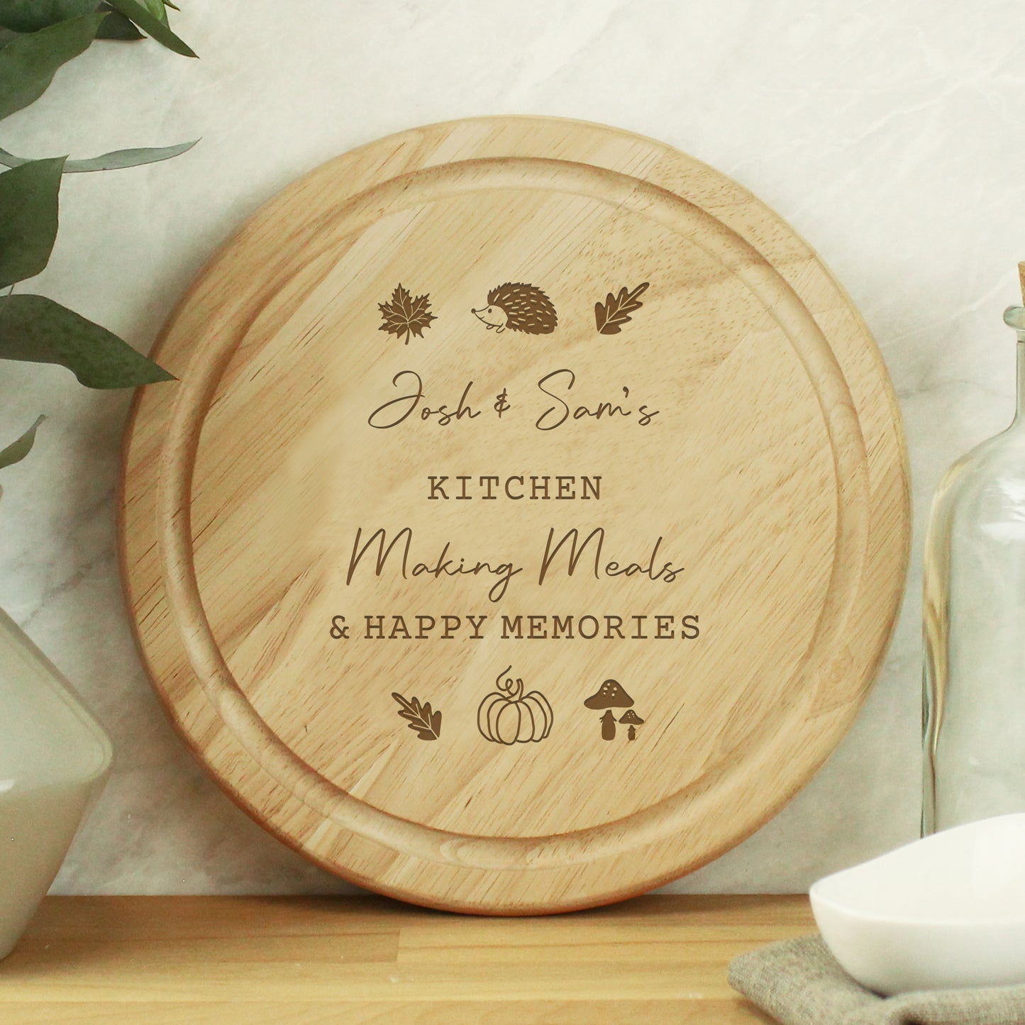 Wooden cutting board with engraved text and illustrations on a kitchen counter.