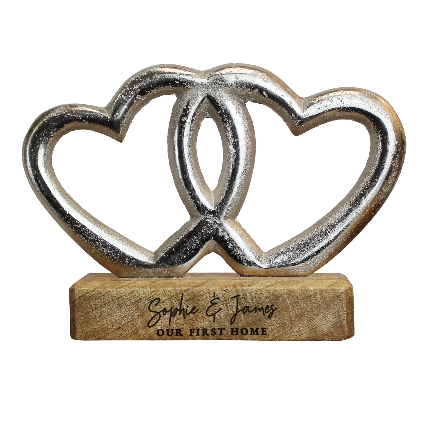 Decorative object with interlocking hearts on a wooden base, engraved with 'Sophie & James Our First Home'.