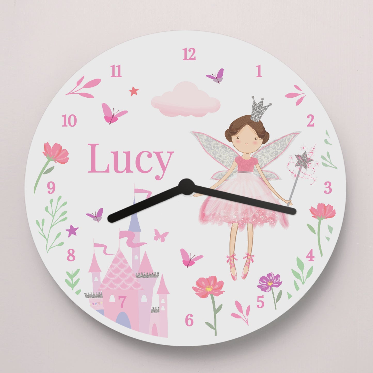 Children's wall clock with fairy design and name 'Lucy' on a light pink background