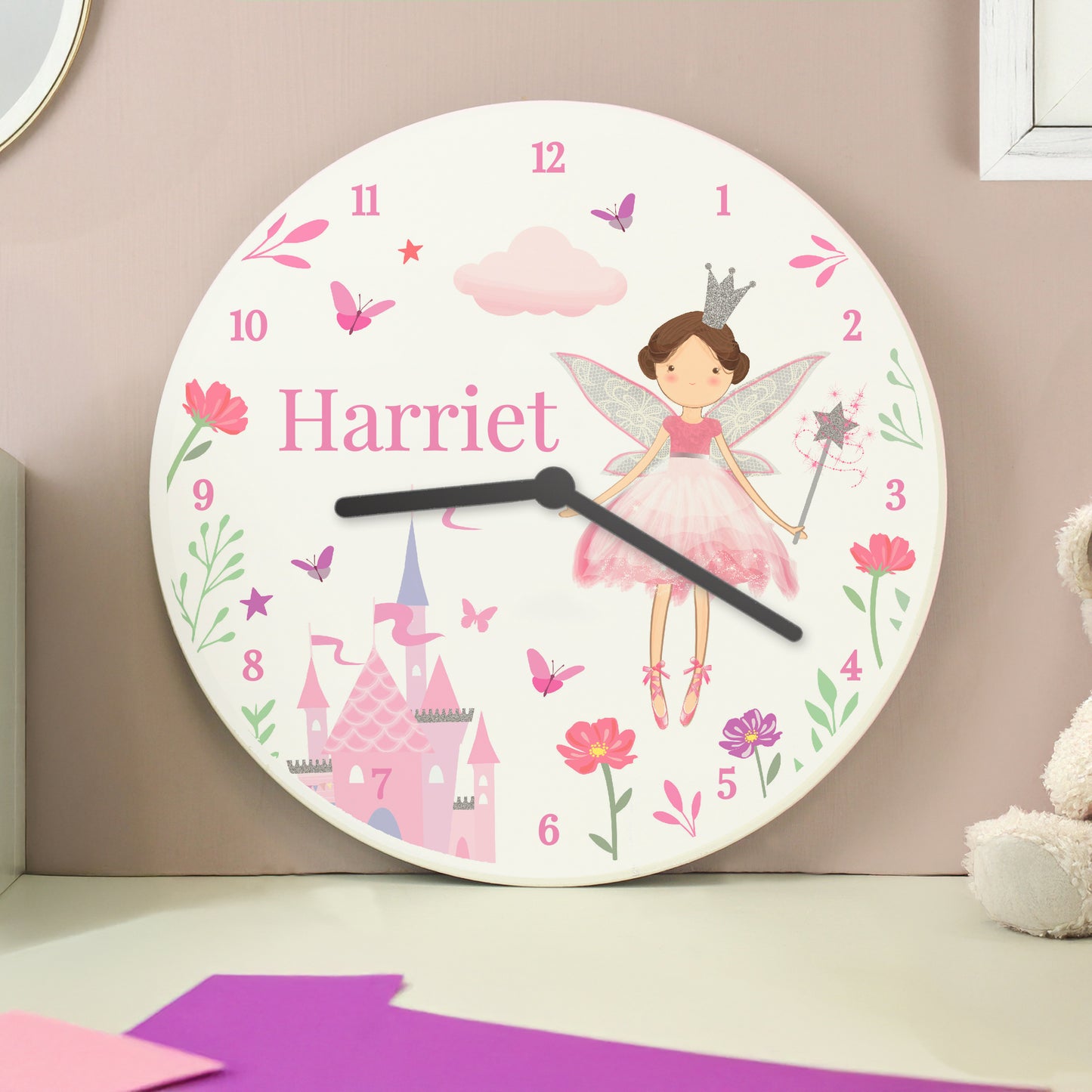 Children's wall clock with fairy design and name 'Harriet' on a pink background