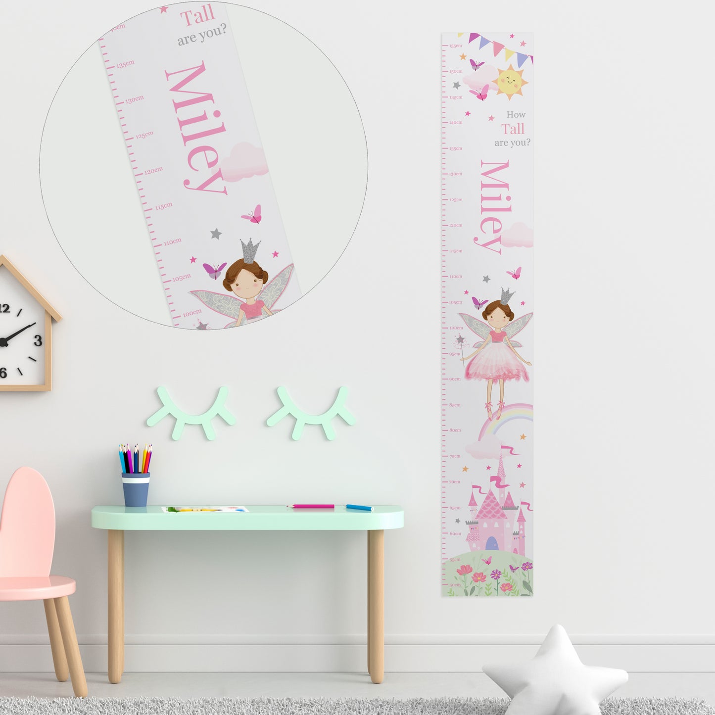 Personalised growth chart with fairy design on a wall above a child's desk.