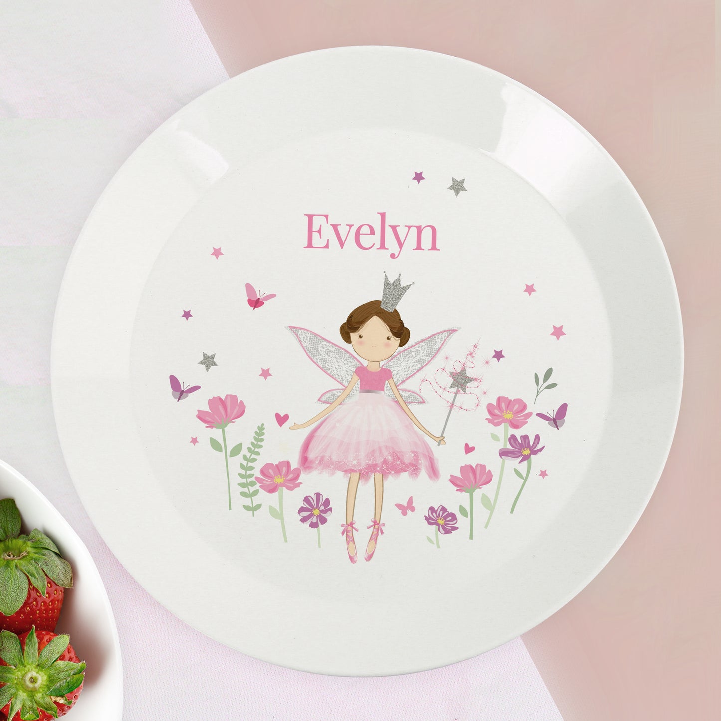 Children's plate with a fairy design and the name 'Evelyn' on a pink background