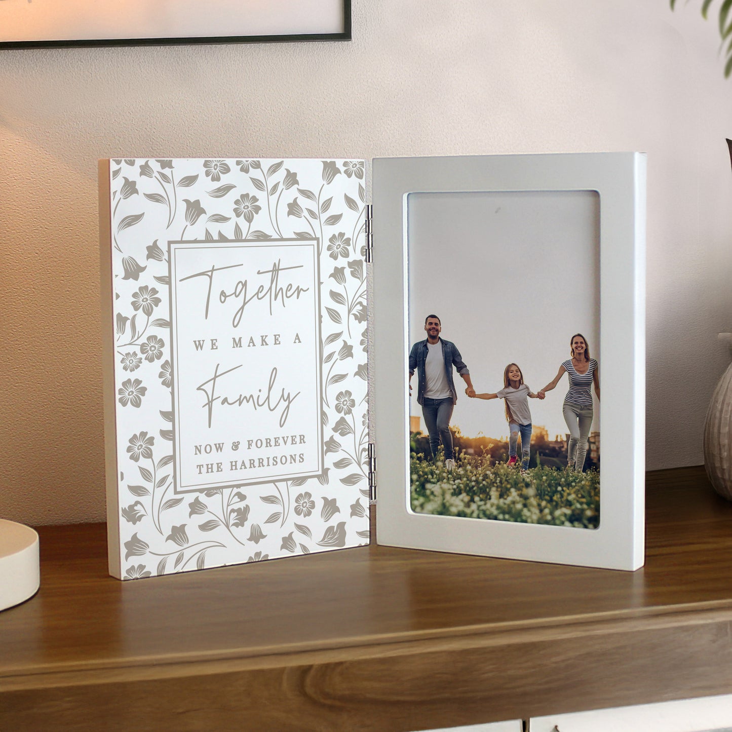 Personalised photo album with floral design and family photo on a wooden surface