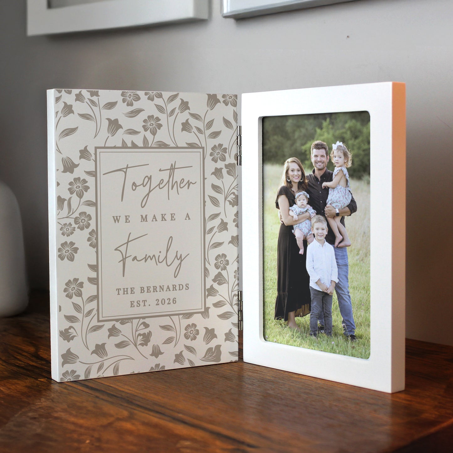 Personalised photo album with family photo and decorative cover on a wooden surface.