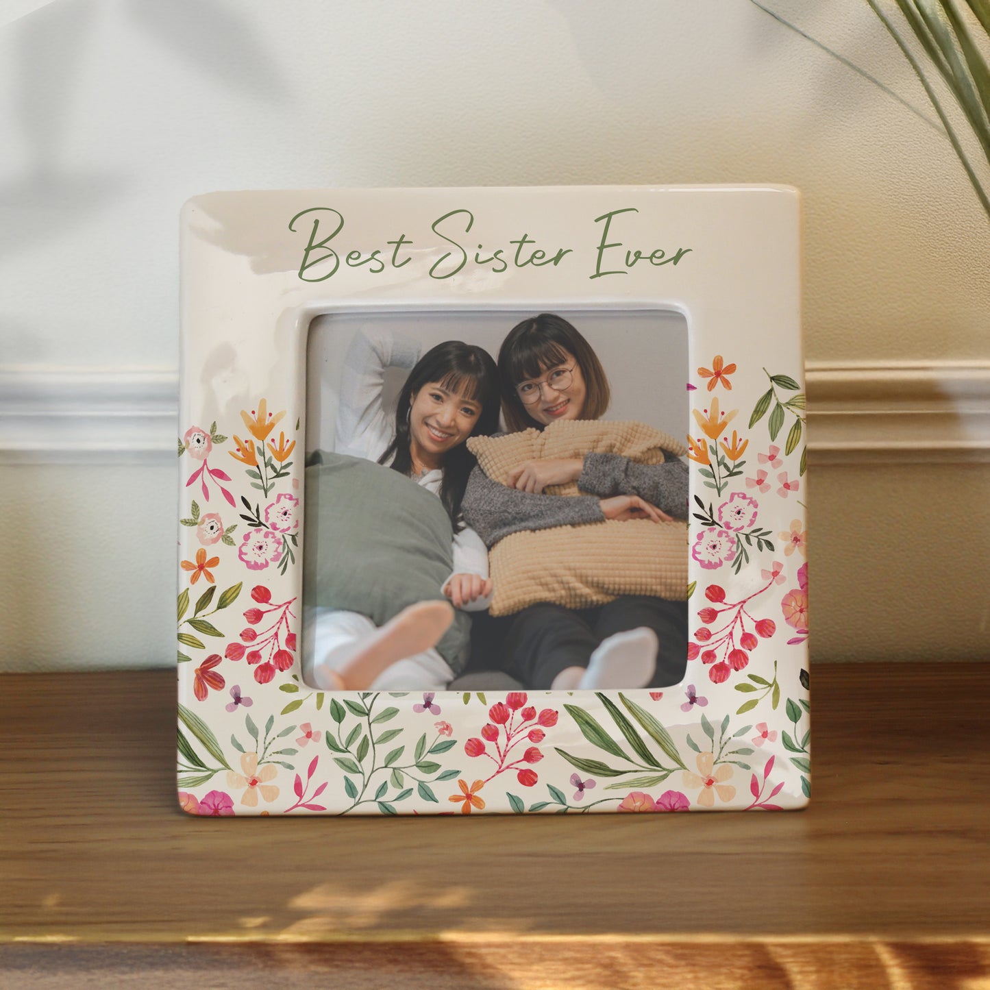 Floral photo frame with 'Best Sister Ever' text containing a photo of two women.