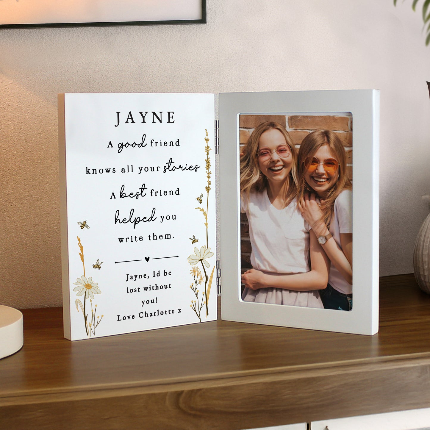 Personalised photo frame with a message and a photo of two people on a wooden surface.