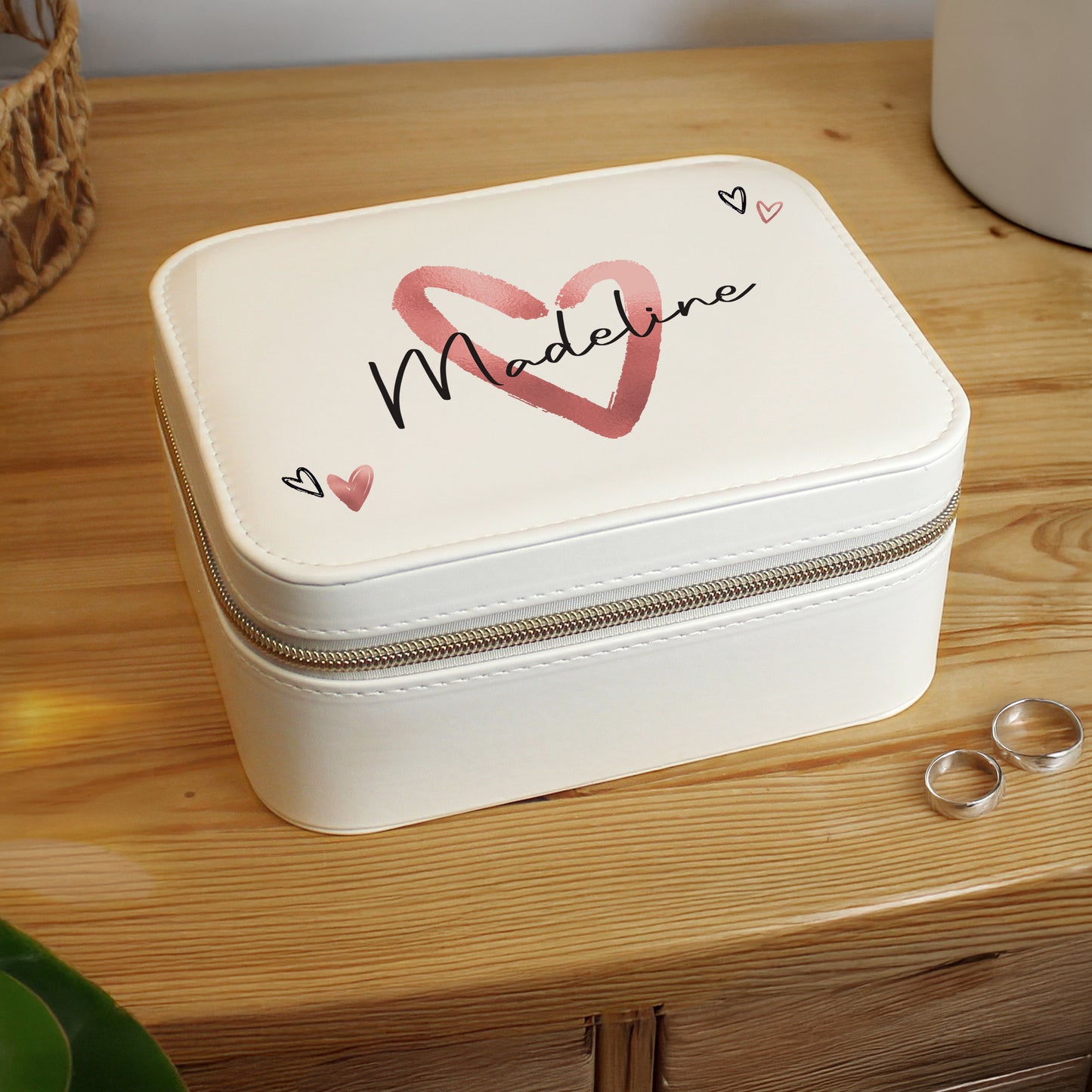 White jewelry box with 'Madeline' and heart designs on a wooden surface