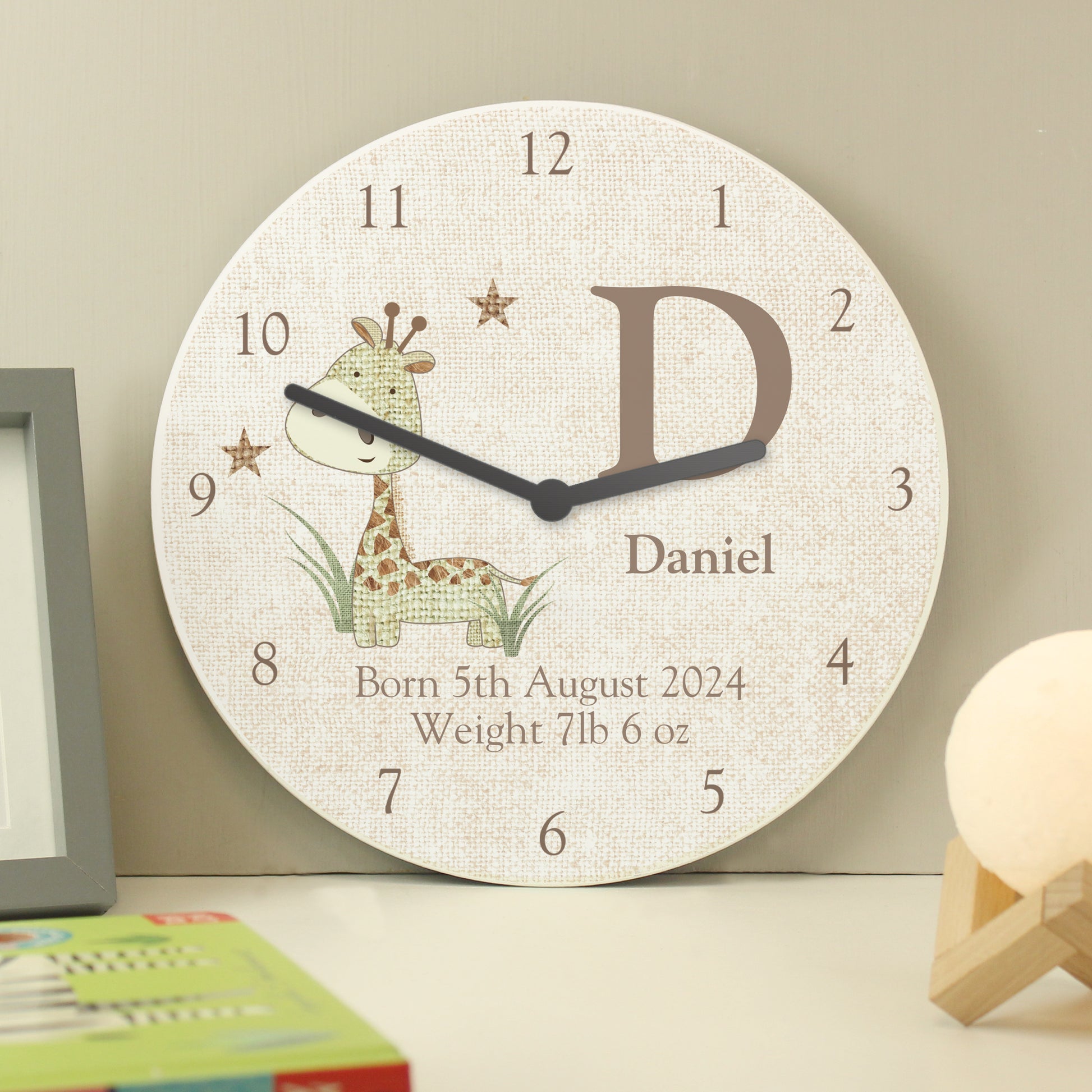 Wooden clock with hessian effect showing cute giraffe and personalisation.