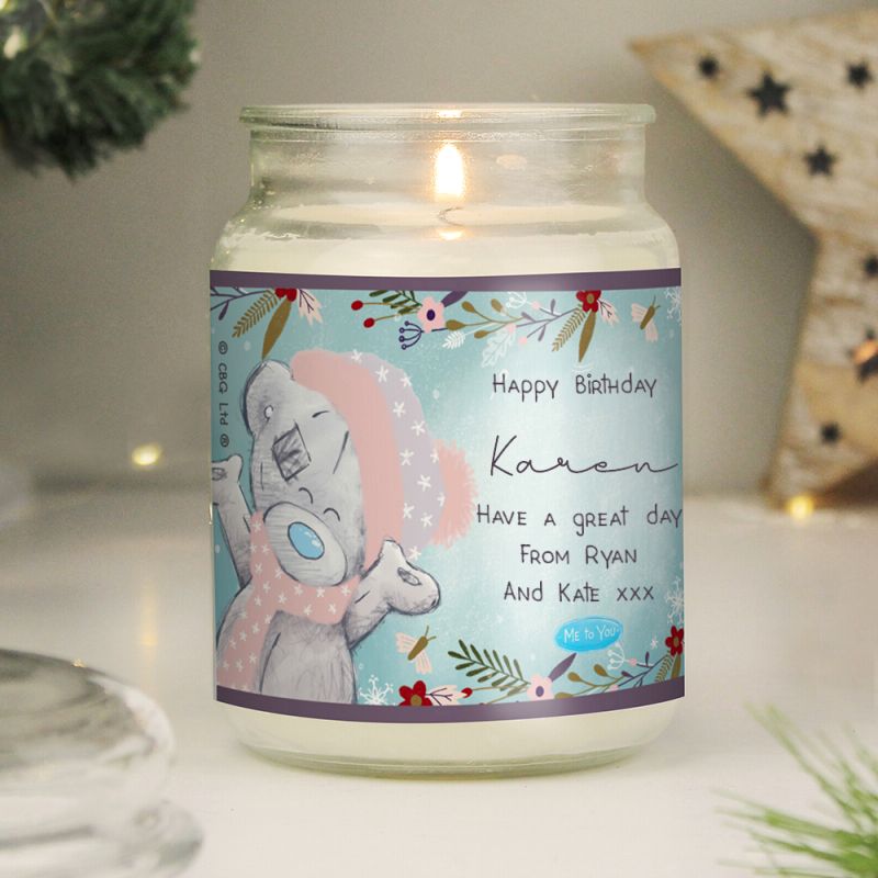 Candle in a glass jar with a personalised label on a decorative background