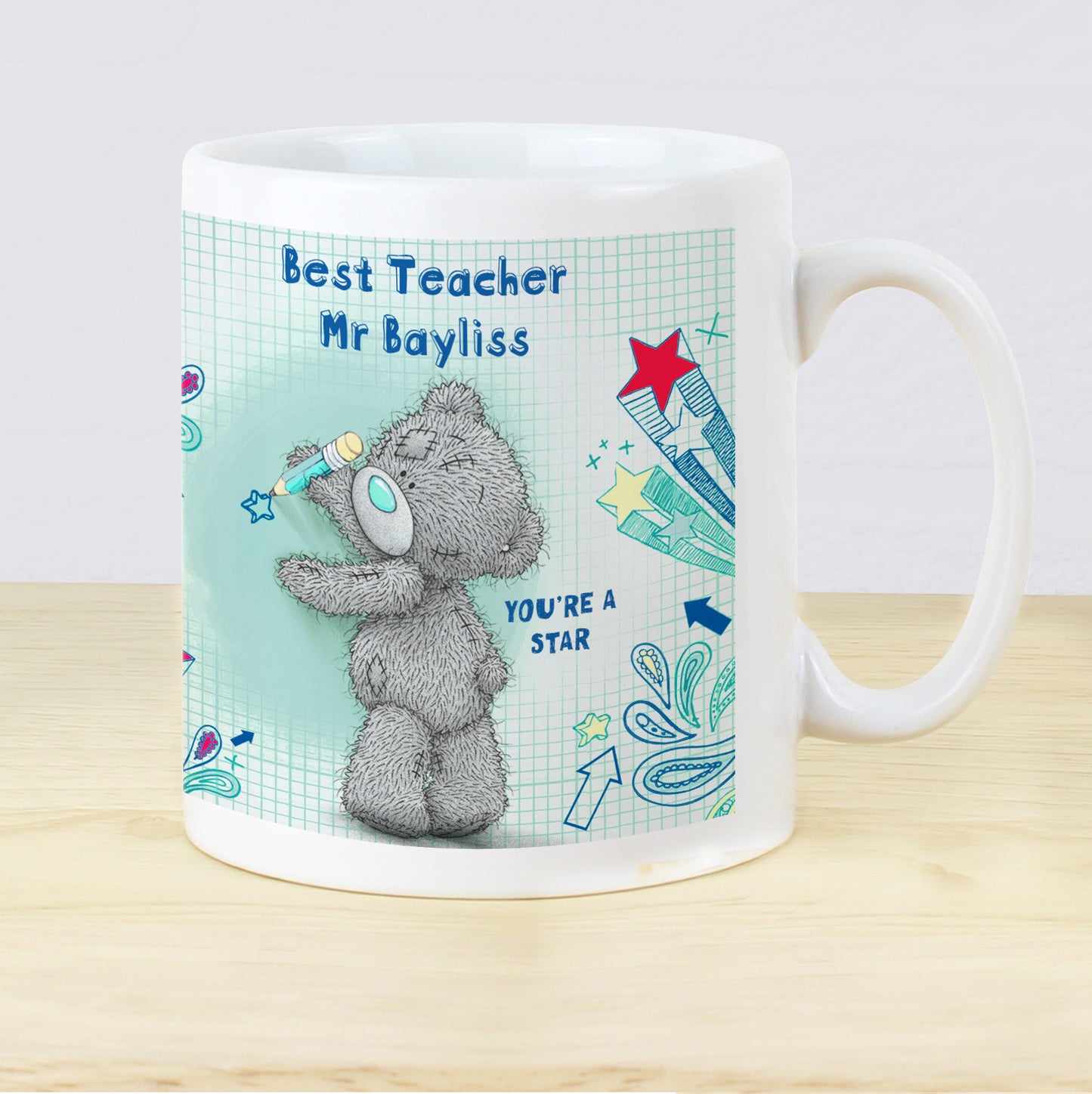 Mug with teddy bear design and personalised text on a light background