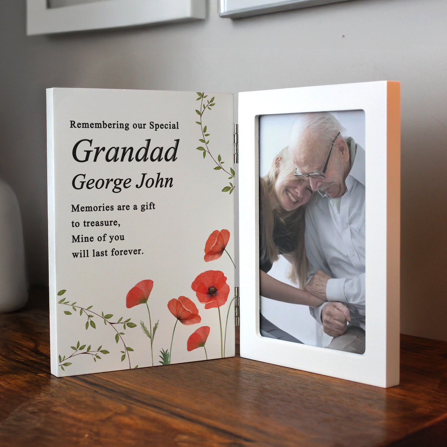 Memorial frame with photo of an elderly couple and text on a wooden surface
