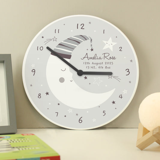 Decorative wall clock with moon and star design on a neutral background
